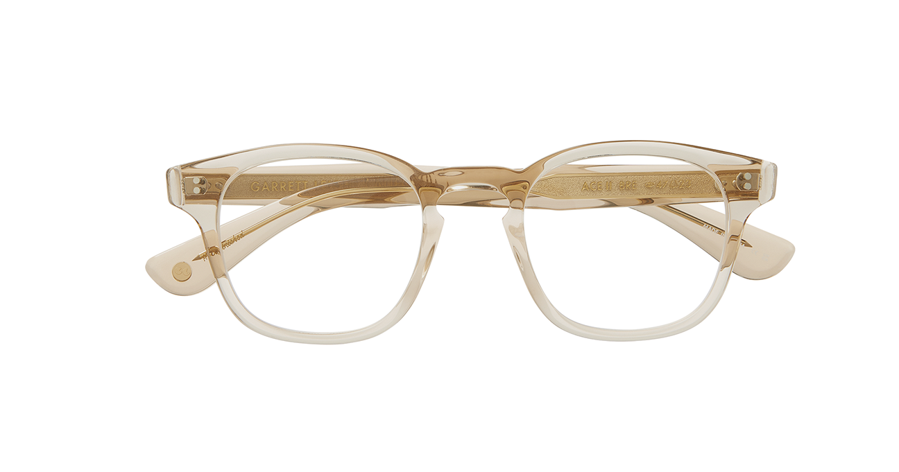 the cult-favorite Ace Sun transformed into an optical. Ace II reflects the standard way in which we design and create premium eyewear. We’re not reinventing the wheel here – just putting some rims on ‘em. In a color we call brew, a translucent frame with a light hue of amber/brown. This image shows the frame with its arms folded.