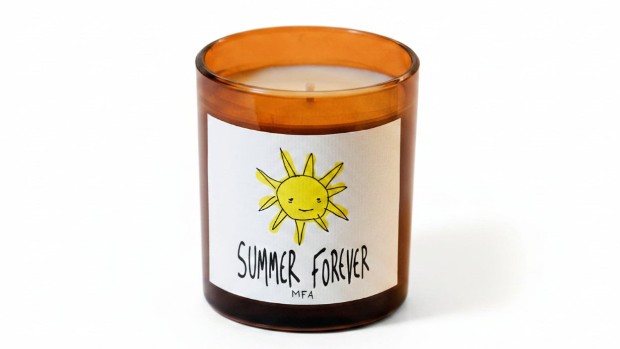 Candle with a sun design and 'Summer Forever' text on a label against a beige background
